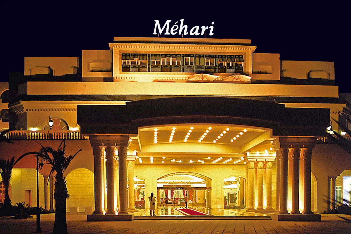 Illuminated Méhari Hammamet entrance at night